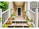 Inviting front porch featuring multiple potted plants and an American flag next to the front door at 1248 Rockview Ct, Loganville, GA 30052
