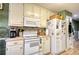 Traditional kitchen with white appliances, countertop, and cabinets, offering a functional and inviting space at 1248 Rockview Ct, Loganville, GA 30052