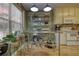 Functional kitchenette space with metal shelving, pots, and natural light, perfect for culinary enthusiasts at 1248 Rockview Ct, Loganville, GA 30052