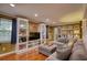 Comfortable living room with a large gray sectional sofa, built-in bookshelves, and warm hardwood floors at 1248 Rockview Ct, Loganville, GA 30052