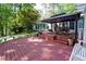 Beautiful outdoor deck and sunroom with an outdoor gazebo and seating for relaxing and entertaining at 2639 Hummingbird Nw Dr, Duluth, GA 30096
