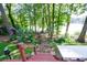 Scenic backyard view with mature trees, landscaping, and stairs that lead to the lake at 2639 Hummingbird Nw Dr, Duluth, GA 30096