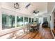 Bright dining room featuring large windows with lake views, wood floors, and a modern light fixture at 2639 Hummingbird Nw Dr, Duluth, GA 30096
