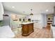 Elegant kitchen with a unique wooden island, white cabinets, and modern appliances at 2639 Hummingbird Nw Dr, Duluth, GA 30096