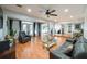 Open-concept living room with hardwood floors, a glass coffee table, and seamless flow to other living spaces at 2639 Hummingbird Nw Dr, Duluth, GA 30096