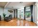 Bright living room featuring hardwood floors, stylish curtains, and a comfortable armchair at 2639 Hummingbird Nw Dr, Duluth, GA 30096