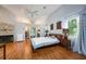 Spacious main bedroom featuring vaulted ceilings, wood floors, and a cozy fireplace at 2639 Hummingbird Nw Dr, Duluth, GA 30096