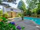 Private backyard oasis featuring a refreshing pool, lush greenery, and a serene seating area at 4512 Woodlawn Lake Dr, Marietta, GA 30068