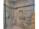 Bathroom with a walk-in shower with tile accents, a built-in shelf and seat at 4512 Woodlawn Lake Dr, Marietta, GA 30068