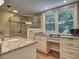 Bright bathroom featuring double granite vanities, a glass-enclosed shower, and a large window at 4512 Woodlawn Lake Dr, Marietta, GA 30068
