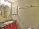 Powder room featuring a red vanity, round mirror and a towel rack at 4512 Woodlawn Lake Dr, Marietta, GA 30068