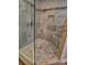 Corner tiled shower with glass door, tiled floor and wall with tiled accents at 4512 Woodlawn Lake Dr, Marietta, GA 30068