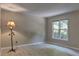 Bright bedroom with neutral walls, wood-look flooring, and a large window at 4512 Woodlawn Lake Dr, Marietta, GA 30068
