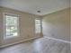 Bright bedroom with neutral walls, wood-look flooring, and two large windows at 4512 Woodlawn Lake Dr, Marietta, GA 30068