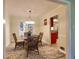 Charming dining room with wicker chairs, glass table and view of the kitchen at 4512 Woodlawn Lake Dr, Marietta, GA 30068
