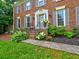 Charming brick home featuring a welcoming front entrance with manicured landscaping and gray shutters at 4512 Woodlawn Lake Dr, Marietta, GA 30068