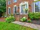Charming brick home featuring a welcoming front entrance with manicured landscaping and gray shutters at 4512 Woodlawn Lake Dr, Marietta, GA 30068