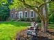 Beautiful brick home with mature landscaping, offering shade and curb appeal at 4512 Woodlawn Lake Dr, Marietta, GA 30068