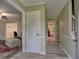 Hallway with wood-look flooring, neutral walls, and access to multiple rooms at 4512 Woodlawn Lake Dr, Marietta, GA 30068