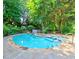Backyard pool with jacuzzi and stone surround provides a luxurious and relaxing outdoor experience at 4512 Woodlawn Lake Dr, Marietta, GA 30068