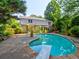 Backyard swimming pool with diving board near lush landscaping for outdoor enjoyment at 4512 Woodlawn Lake Dr, Marietta, GA 30068