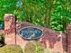 Stone monument sign for Woodlawn Lake community surrounded by greenery at 4512 Woodlawn Lake Dr, Marietta, GA 30068