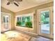 Cozy sunroom with lots of windows overlooking the landscaped backyard and pool at 4512 Woodlawn Lake Dr, Marietta, GA 30068