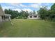 Expansive backyard featuring a long lawn and a detached building with many windows at 6880 Mark Turner Rd, Lithia Springs, GA 30122