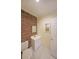 Bathroom features brick wall, white sink, and cabinets to create a modern design at 6880 Mark Turner Rd, Lithia Springs, GA 30122