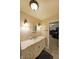 Well-lit bathroom featuring a vanity with a marble countertop and decorative sconces at 6880 Mark Turner Rd, Lithia Springs, GA 30122
