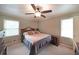 Bedroom features a ceiling fan, large window, and neutral paint, creating a calm retreat for relaxation and rest at 6880 Mark Turner Rd, Lithia Springs, GA 30122