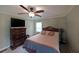 Cozy bedroom features ceiling fan, closet, and warm wall color creating an inviting and relaxing atmosphere at 6880 Mark Turner Rd, Lithia Springs, GA 30122
