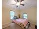 Bedroom featuring a ceiling fan, two windows, and neutral paint, creating a serene and calm atmosphere at 6880 Mark Turner Rd, Lithia Springs, GA 30122