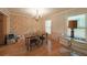Traditional dining room boasting hardwood floors, elegant chandelier, and natural light through windows at 6880 Mark Turner Rd, Lithia Springs, GA 30122
