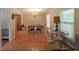 Traditional dining room boasting hardwood floors, elegant chandelier, and natural light through windows at 6880 Mark Turner Rd, Lithia Springs, GA 30122