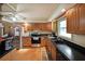 Functional kitchen featuring black countertops, stainless steel appliances, and classic wood cabinets at 6880 Mark Turner Rd, Lithia Springs, GA 30122