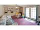 Cozy living room showcasing a brick fireplace, built-in shelving, and natural light from glass doors at 6880 Mark Turner Rd, Lithia Springs, GA 30122