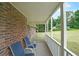 A cozy porch with brick and two chairs, offering an inviting outdoor space at 6880 Mark Turner Rd, Lithia Springs, GA 30122