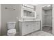 Bright bathroom with dual sinks, large mirror, and modern white cabinets at 2793 Keystone Ave, Lithonia, GA 30058