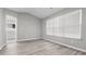 Bedroom with vaulted ceiling, lots of light, and stylish, light grey flooring at 2793 Keystone Ave, Lithonia, GA 30058