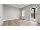 Bright bedroom with natural light, ceiling fan, neutral walls, and direct access to outdoor space at 2793 Keystone Ave, Lithonia, GA 30058