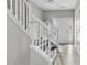 Bright foyer with a staircase, white railings, and stylish flooring leading to the rest of the home at 2793 Keystone Ave, Lithonia, GA 30058