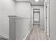 Hallway featuring neutral walls and modern flooring, with bedroom view at 2793 Keystone Ave, Lithonia, GA 30058