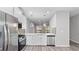 Beautiful eat-in kitchen with stainless steel appliances, white cabinets, and modern light fixtures at 2793 Keystone Ave, Lithonia, GA 30058
