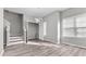 An open-concept living room with hardwood floors with stairs and an adjacent closet at 2793 Keystone Ave, Lithonia, GA 30058