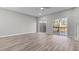 Spacious living room with hardwood floors, access to a patio, and neutral wall color at 2793 Keystone Ave, Lithonia, GA 30058