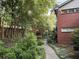 A peaceful outdoor area with a stone walkway leading to a pergola, surrounded by lush greenery and a brick wall at 425 Lindbergh Ne Dr # A2, Atlanta, GA 30305