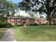 Exterior view of a two-story brick home with a well-maintained lawn and mature trees surrounding the property at 425 Lindbergh Ne Dr # A2, Atlanta, GA 30305