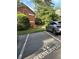 Reserved parking space next to a brick two-story home with lush green landscaping and mature trees at 425 Lindbergh Ne Dr # A2, Atlanta, GA 30305