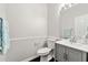 Well-lit half-bathroom with a modern vanity and neutral wall color at 7505 Brookwood Way, Cumming, GA 30041